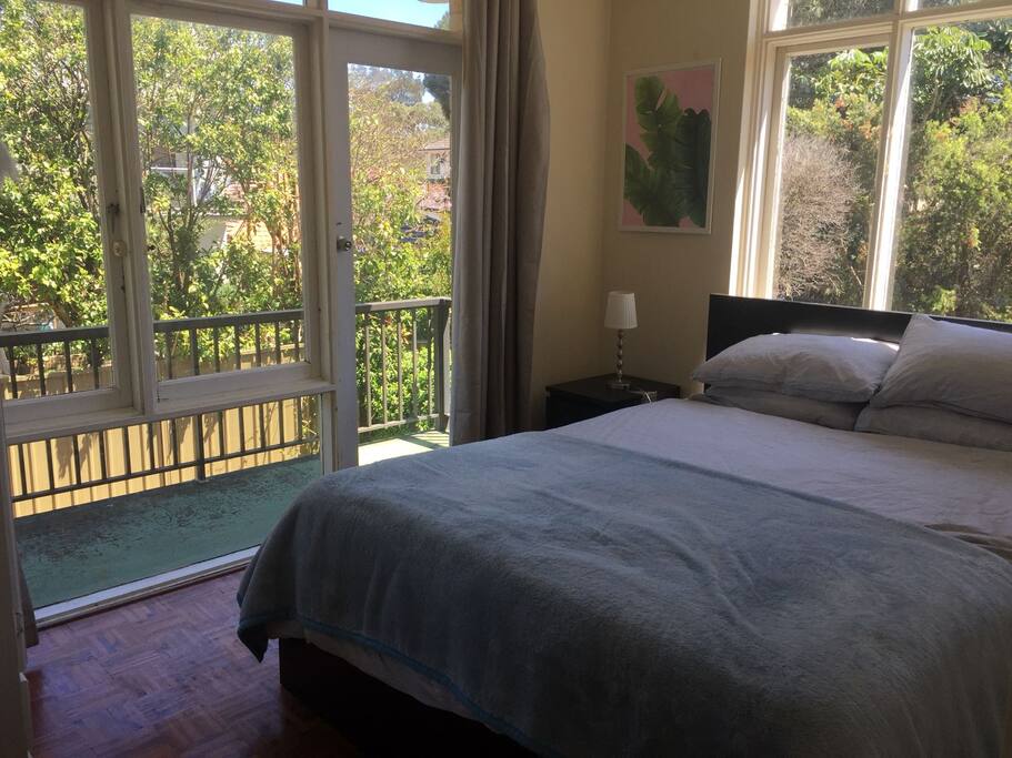 2nd Bedroom with Queen sized bed and balcony view.