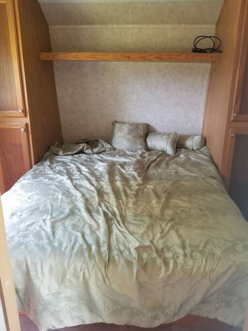 The main bedroom has a queen size bed and plenty of cabinet, storage space and closets.