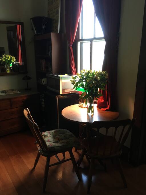 Microwave and refrigerator by the little breakfast table