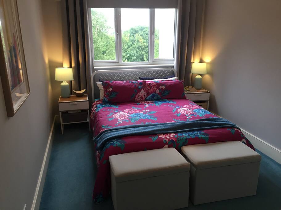 Tranquil bedroom w/ roller-blind/blackout curtains, air purifier, & closet space.