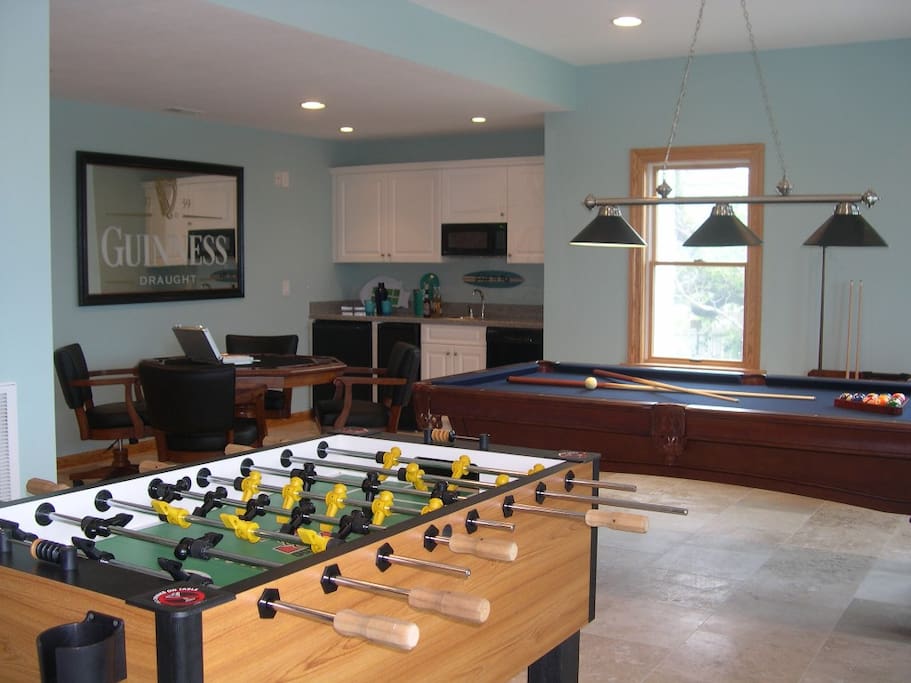 Game room with pool table, foosball, card table, wet bar
