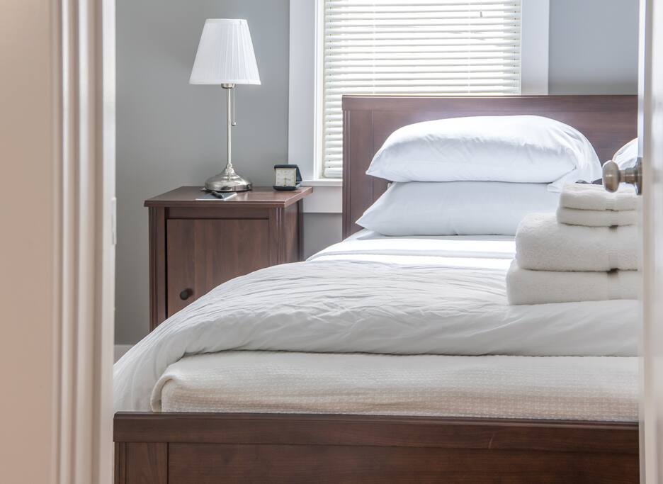 Bedroom accommodates two guests in queen size bed.