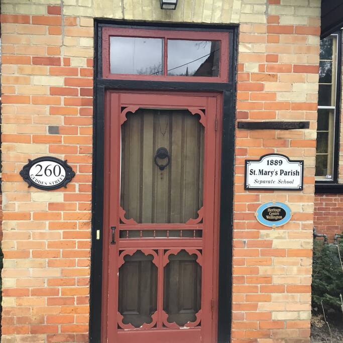 This entrance notes the heritage designation of the 1889 schoolhouse