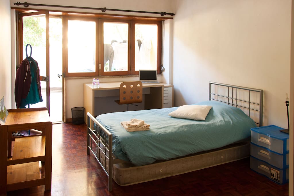 There's a single but big bed and an extra mattress. The room is very big and there's enough space for two people!
A big window door is the access to the terrace
