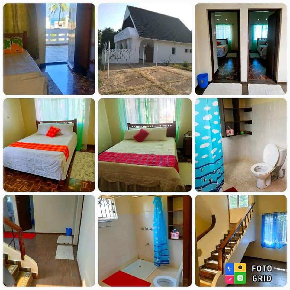 A collage of images showcases various areas of the accommodation. A well-lit bedroom features a bed with colorful linens. Bathrooms are neatly arranged with modern fixtures. A staircase is visible, leading to additional living spaces. Natural light filters through sheer curtains, enhancing the welcoming atmosphere.