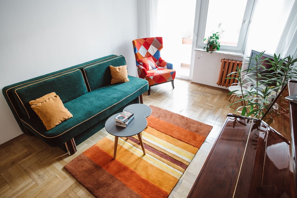 Living room with piano, balcony and garden view
