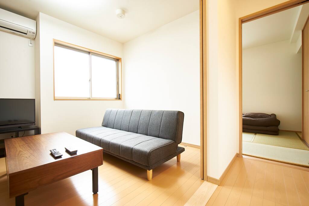 Living room with terrestrial Japanese TV available. Sofa turns into a bed.