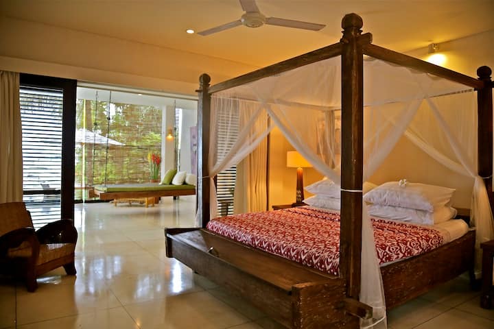 The downstairs bedroom  has both AC and fan, as well as wooden louvred doors to keep you comfortable