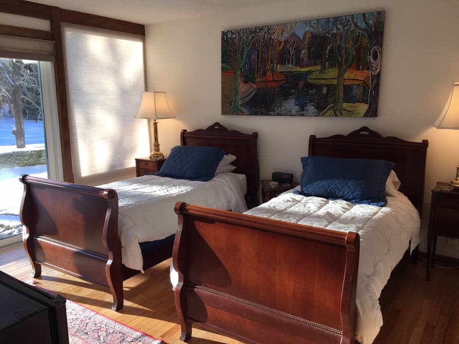 The terrace room overlooks the pond with two twin beds.