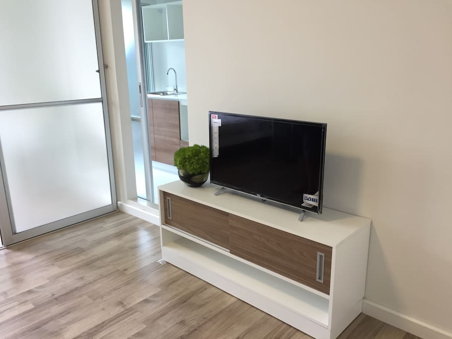 TV set and sliding door to kitchen and bathroom