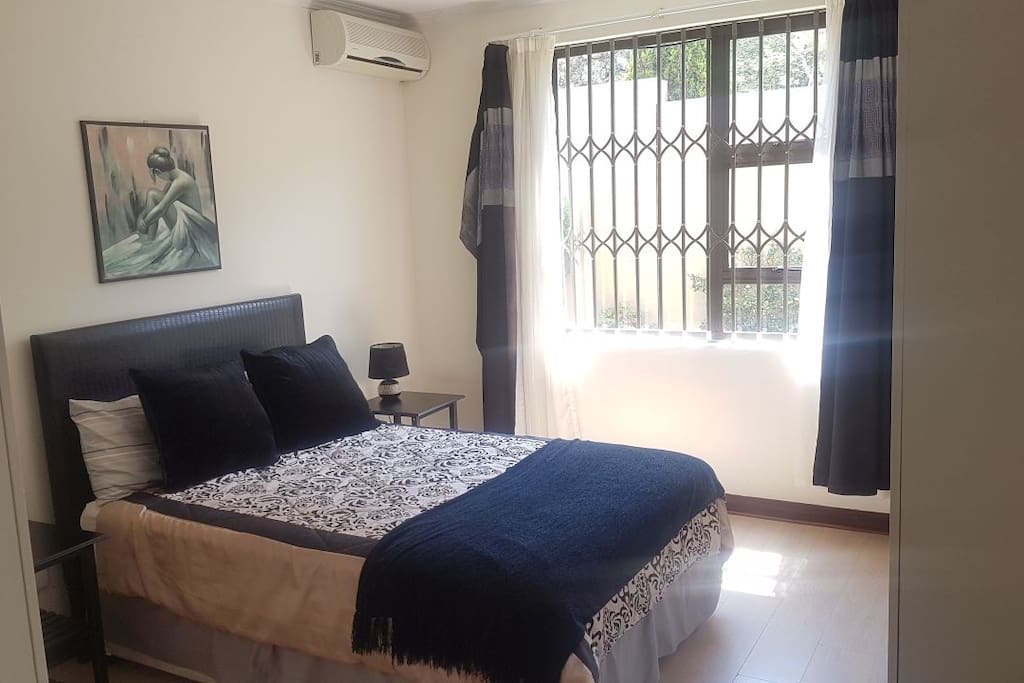 Spacious main bedroom with air-conditioning