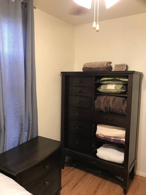 The one nightstand by the bedside lines up with the operable window and followed by the high 6 drawer chest.