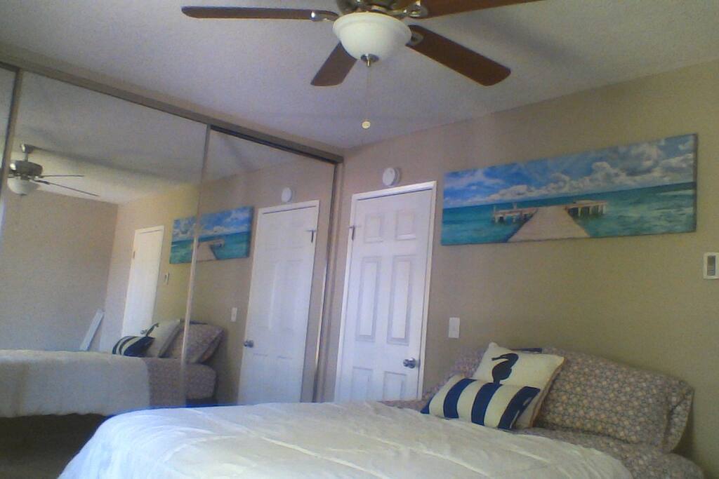 Upstairs, Mirrored closet doors, blackout drapes and ceiling fan. Door leads to private bathroom with double sinks.