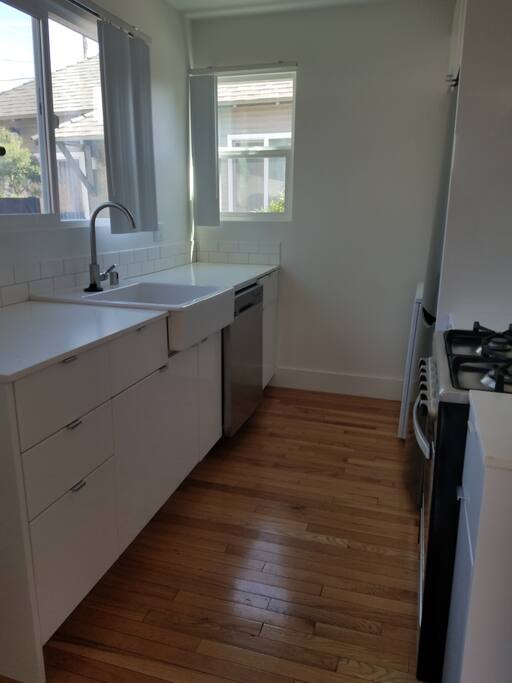 Full kitchen with refrigerator, dishwasher, and microwave