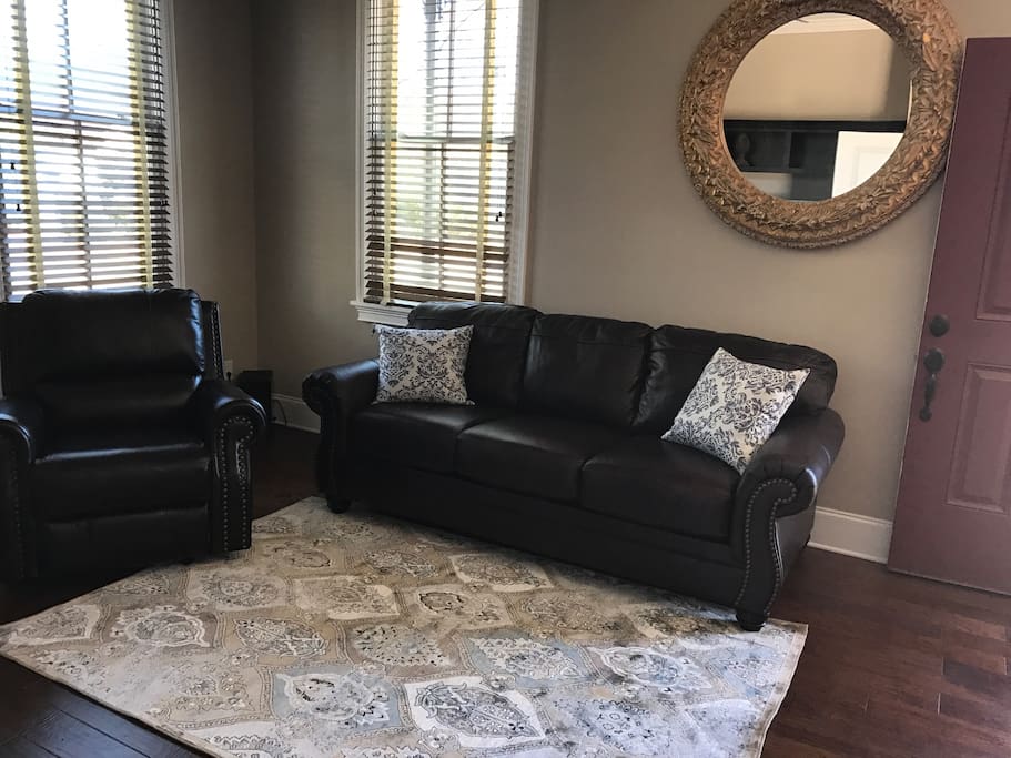 Living area includes a 55" 4K Samsung TV with Sound bar and blue tooth adapter. Half bath is located near by.