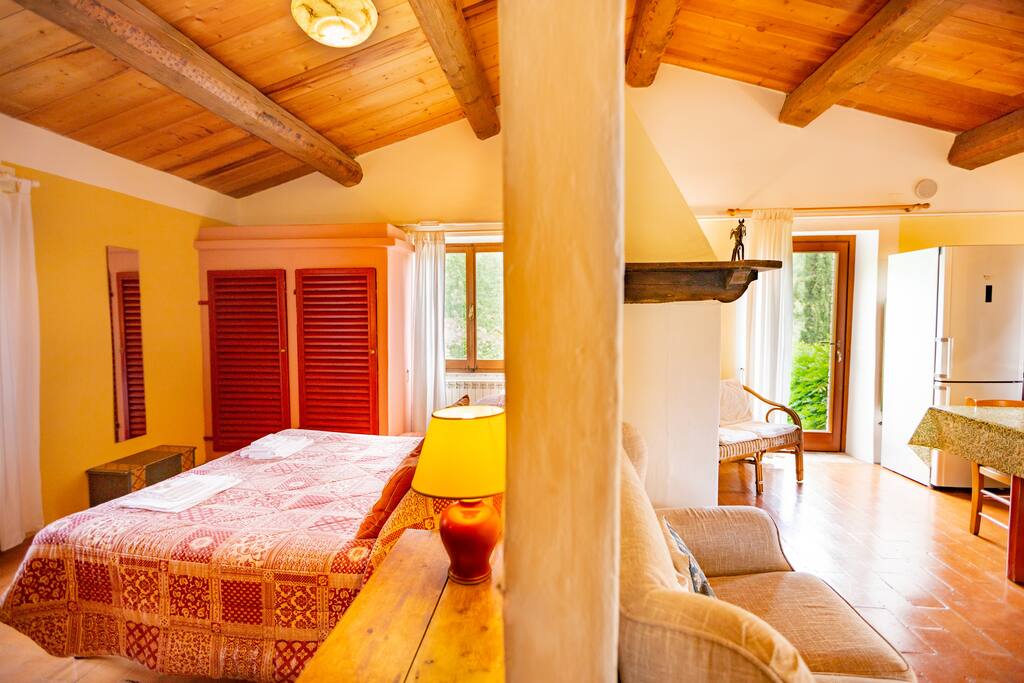Living room with fireplace, dining table and six chairs, easy chair, and Wi-Fi access, wood-burning stove, and access to balcony with panoramic views over the National Park.