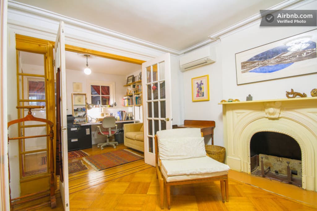 The front bedroom has an adjoining space with a pull out couch for one person. The french doors close.