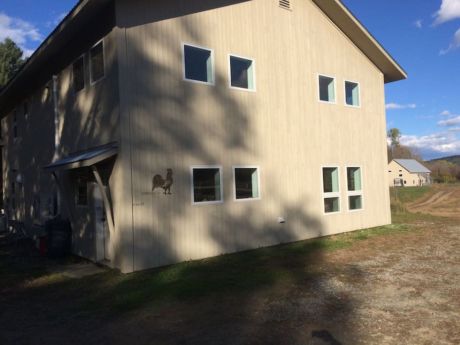 To find the apartment, find this building with the glittery rooster! The apartment is on the second floor. Bear right and make a left behind the building to find the apartment entrance!