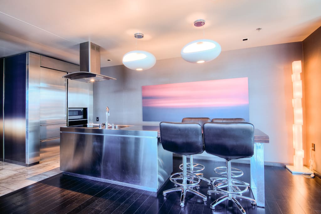 Fully equipped kitchen with flattop stove and bar seating