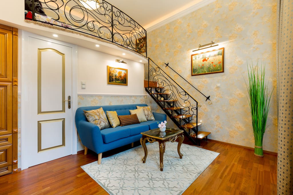 Living area with stairs leading up to sleeping area on mezzanine