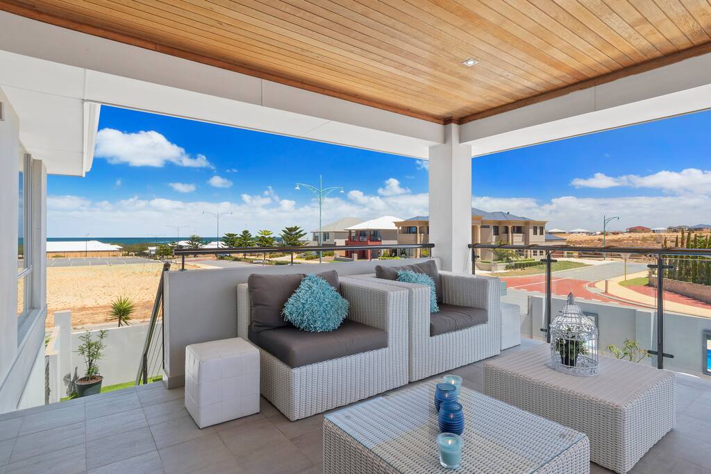 Balcony entertaining with stairs leading down to pool . Views to pool & ocean.