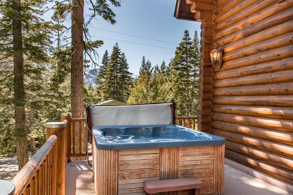 Soak in the hot tub on the deck with mountain views through the pines.