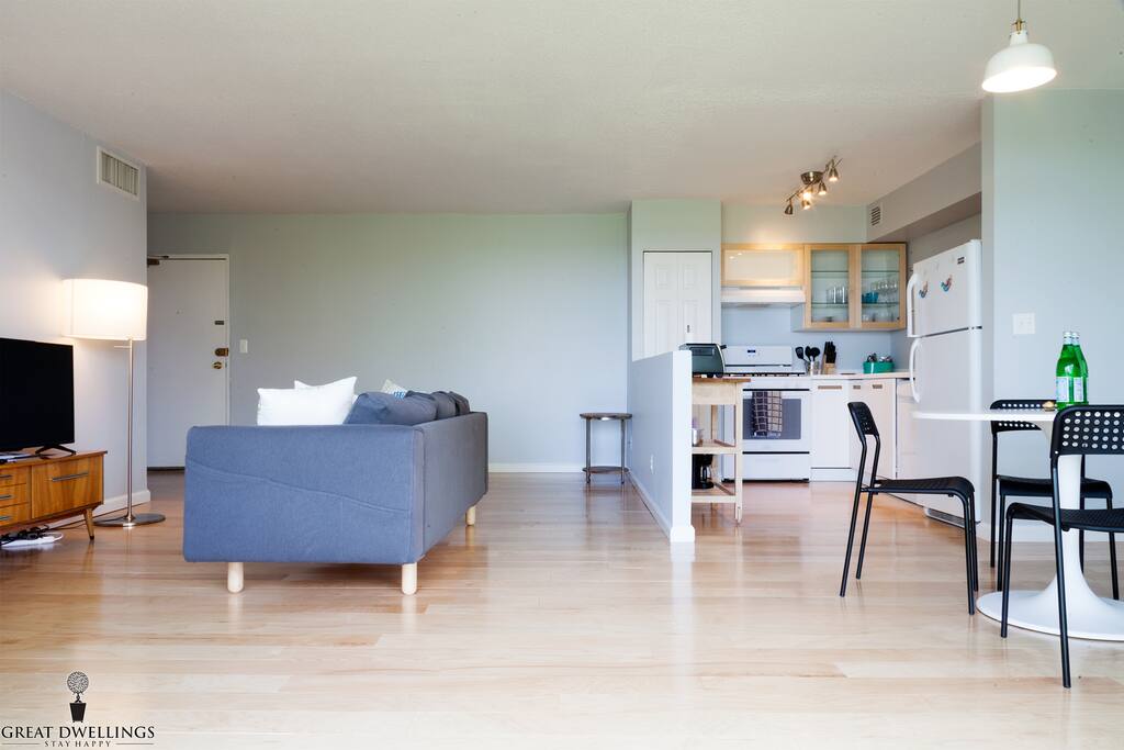 Well lit living room, dining area and kitchen.