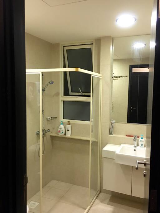 clean and bright washroom with shampoo and essentials
