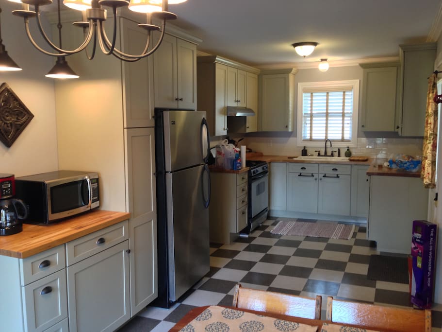The Magnolia House kitchen is a fully equipped space perfect for dining in and having your morning coffee or sitting out on the adjoining deck through the French doors