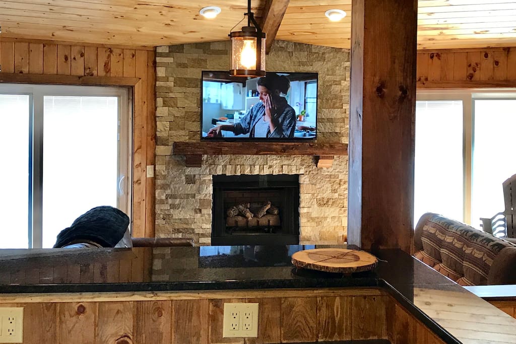 Living room is equipped with a 55' smart tv, fireplace, sofas and access to the spacious deck.
