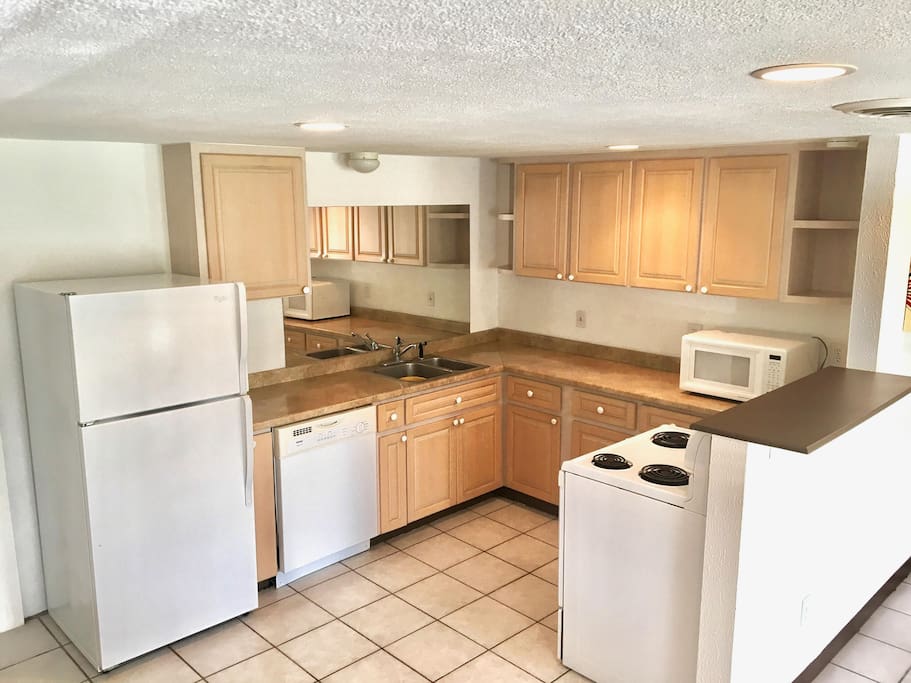 Full kitchen with appliances and housewares.