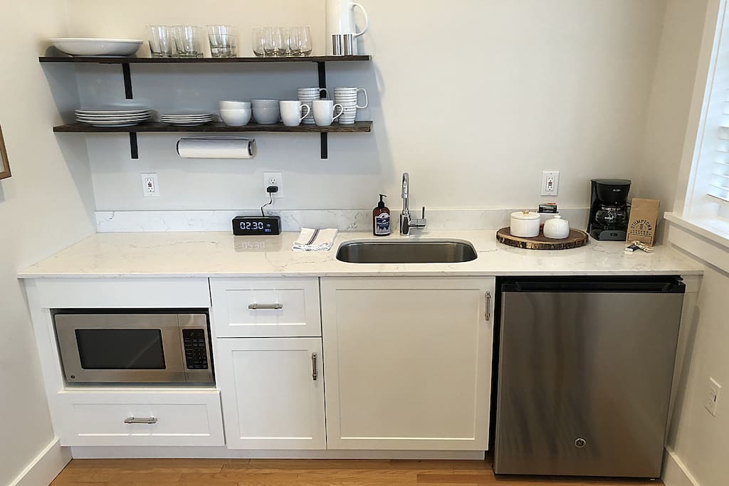 An updated kitchenette with marble counter.