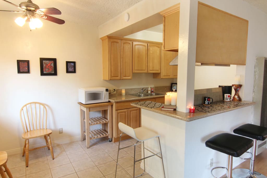 Modern remodeled kitchen features gas stove, microwave, stainless steel fridge and granite counters!