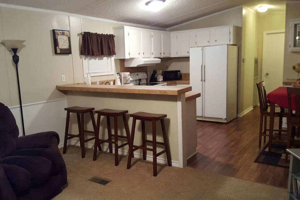 Fully equipped kitchen with microwave and dishwasher. Complete selection of pots and pans and dinnerware. Dining table for four and a bar that serves three.