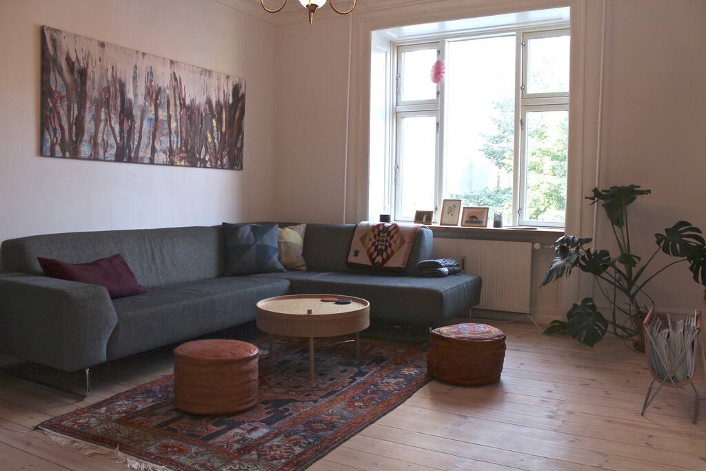 Living room with comfy couch that doubles as a guest bed - UPDATE: We've recently put up a 4K Smart TV with Netflix and HBO Nordics in the living room.