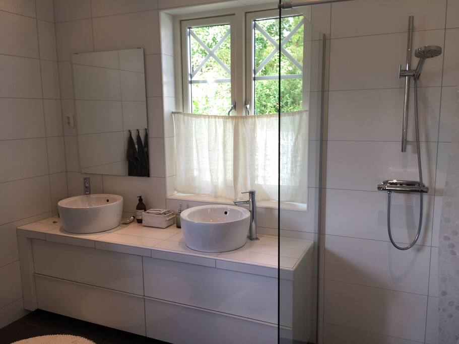 Large bathroom with shower and bathtub.
