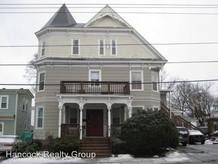 Recent picture of building. Second and third floor are one single unit; very large space. Two available bedrooms both on second floor. Third floor occupied by three residents. Two parking spaces available, as well as street parking.