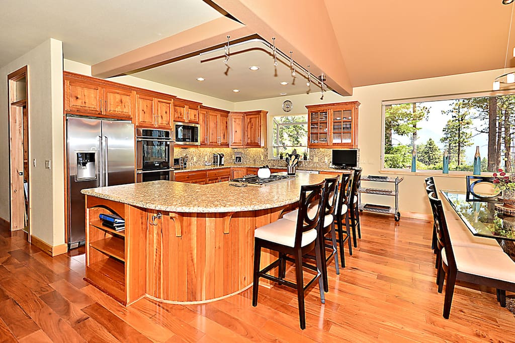 The kitchen, open to the dining space, features a large island that seats 4.