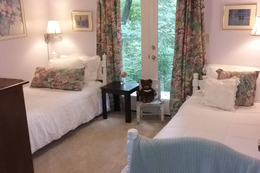 Another view of the floral bedroom with twin beds. Access to back porch through these doors