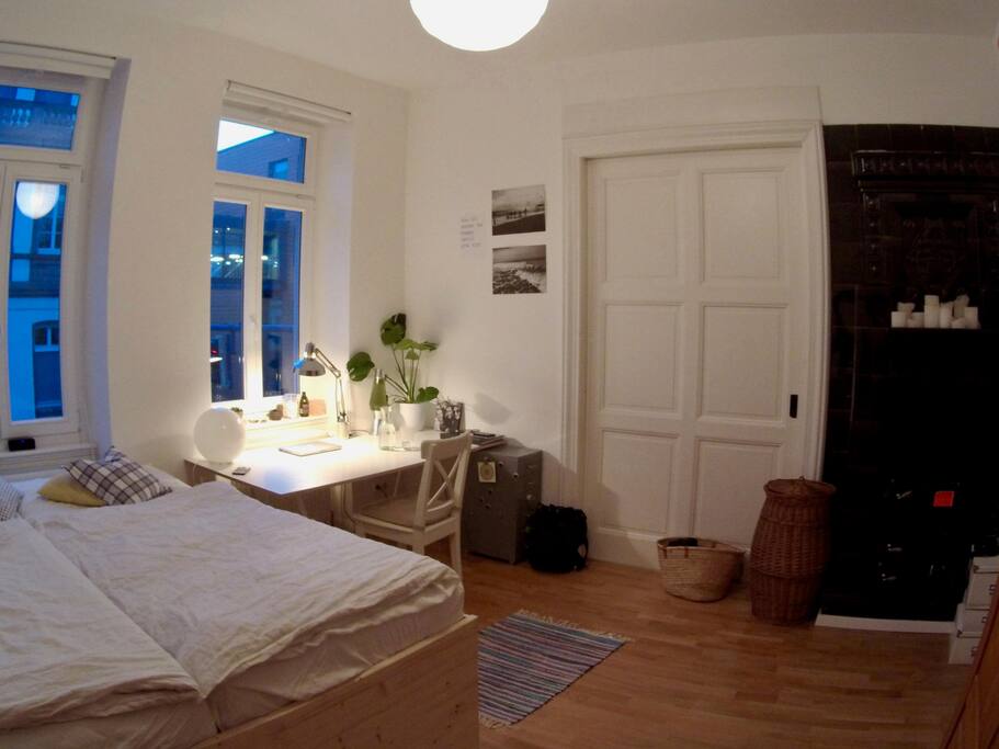 Your room with a big workplace and a beautiful old furnace