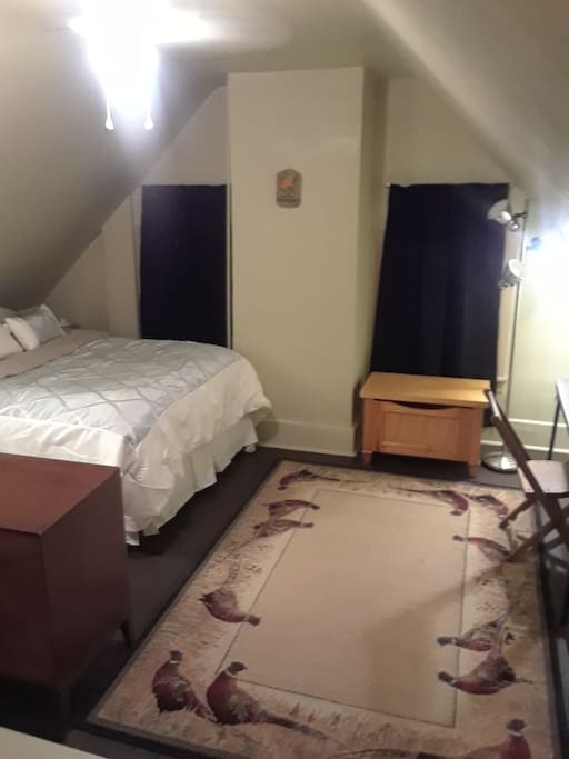 Warm and cozy double bed with full size dresser and closet. 1 half of 2 room separated with privacy drapes and stairs. Single locked door to both rooms.