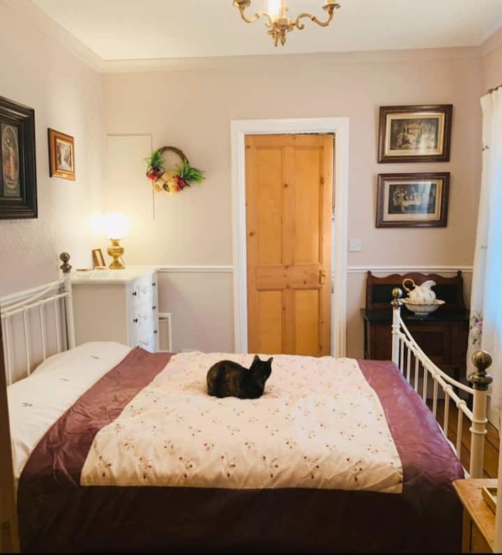 Airbnb guest room.
There is a wardrobe behind the door and a desk on the right hand side of the door. 