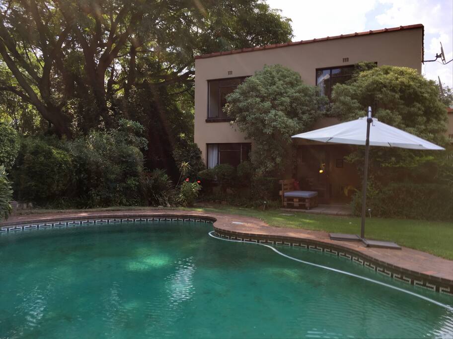 Double story apartment in lush garden with pool