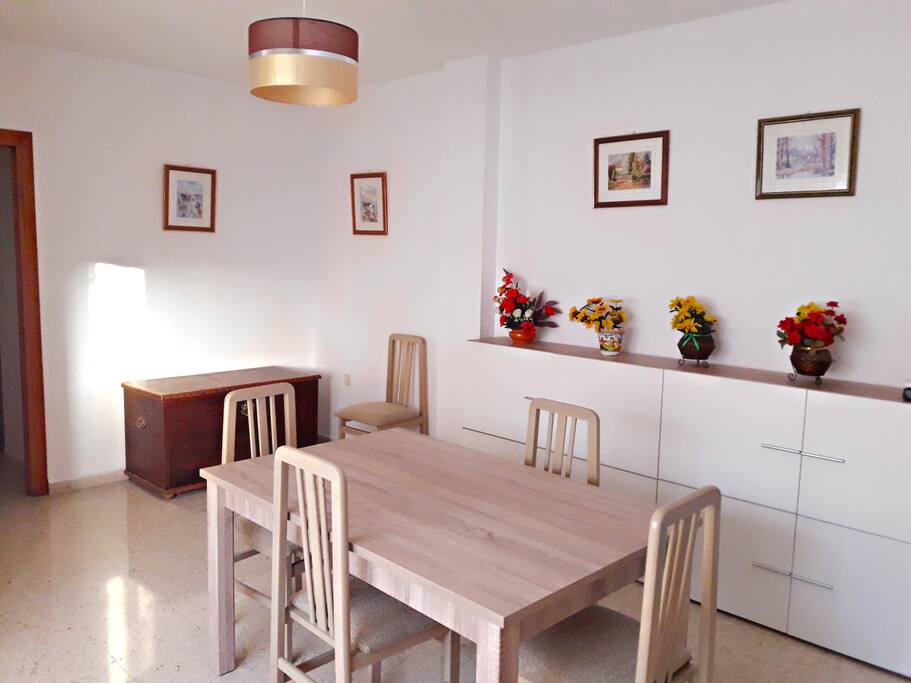 Wide dining room with central dinner table.