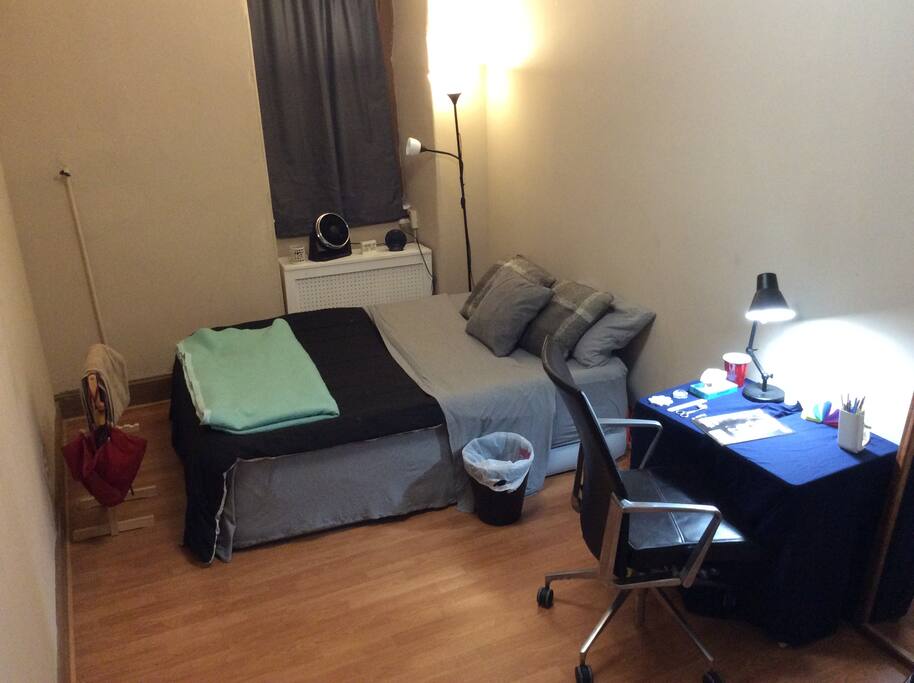 The bedroom is equip with a large closet, desk, love seat and bed.