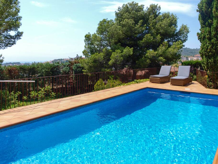 Swimming pool area with views of the sea