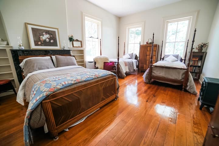 The Grace Room gets lots of evening light from the setting sun.  You can see the sheep grazing across the road out the front windows. It has a queen bed and two single beds. It's on the 2nd floor.