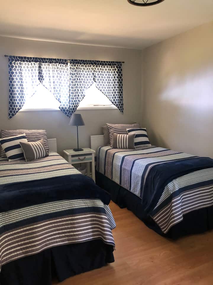 Twin X-tra Long beds with new mattresses and linens.