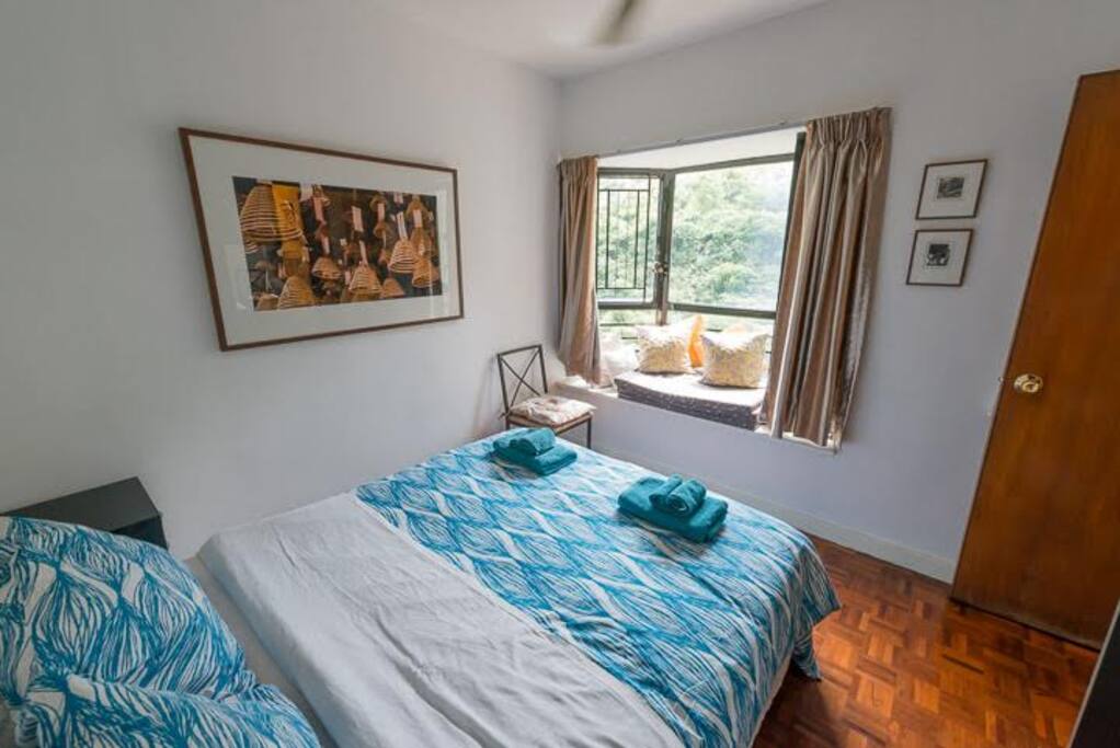 Bright and airy back bedroom with bay windows of hill side views
