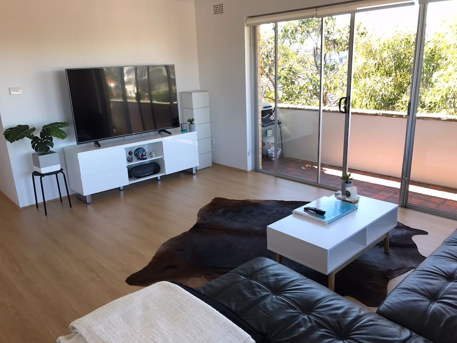 Spacious and Bright Lounge Room with 65 inch smart LED TV, DVD player and Netfilx